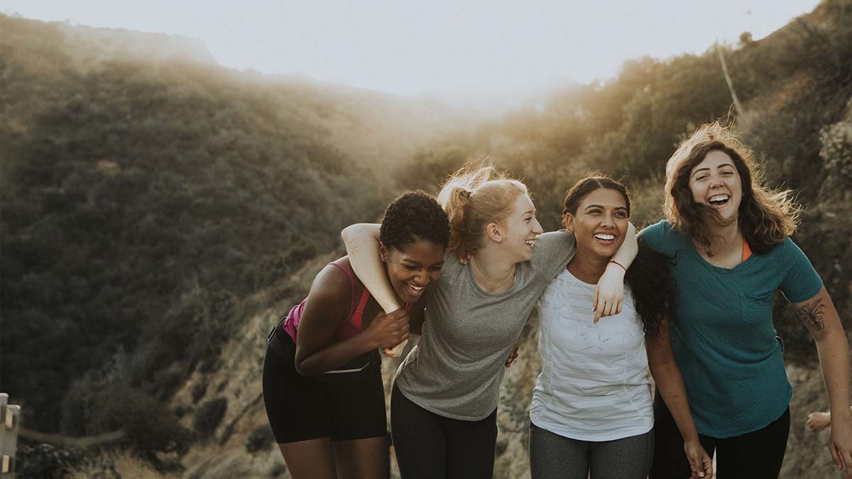Four girls hiking at sunset